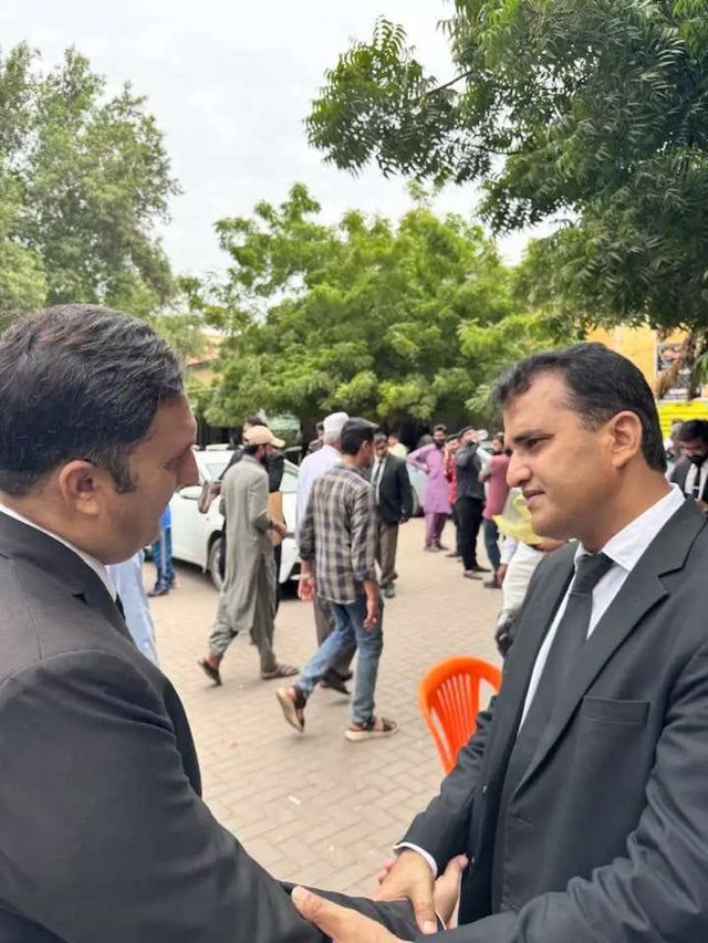 Two advocates greeting each other outdoors