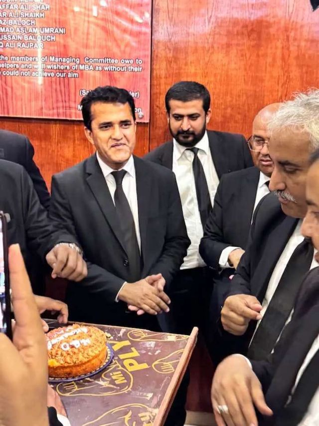 Advocates cutting a cake at a Bar association event