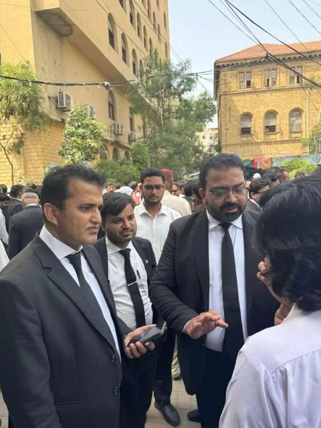Advocates in conversation outside a courthouse