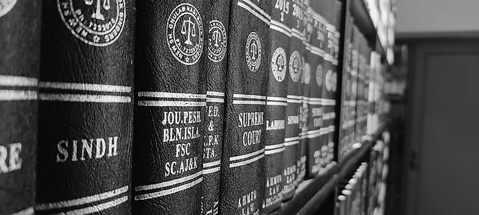 Row of bound Sindh law reports and Supreme Court law journals on a shelf